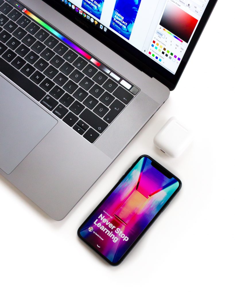 Picture of an iPhone X and a MacBook that’s showcasing graphic design work  | Black Flag Creative, Los Angeles